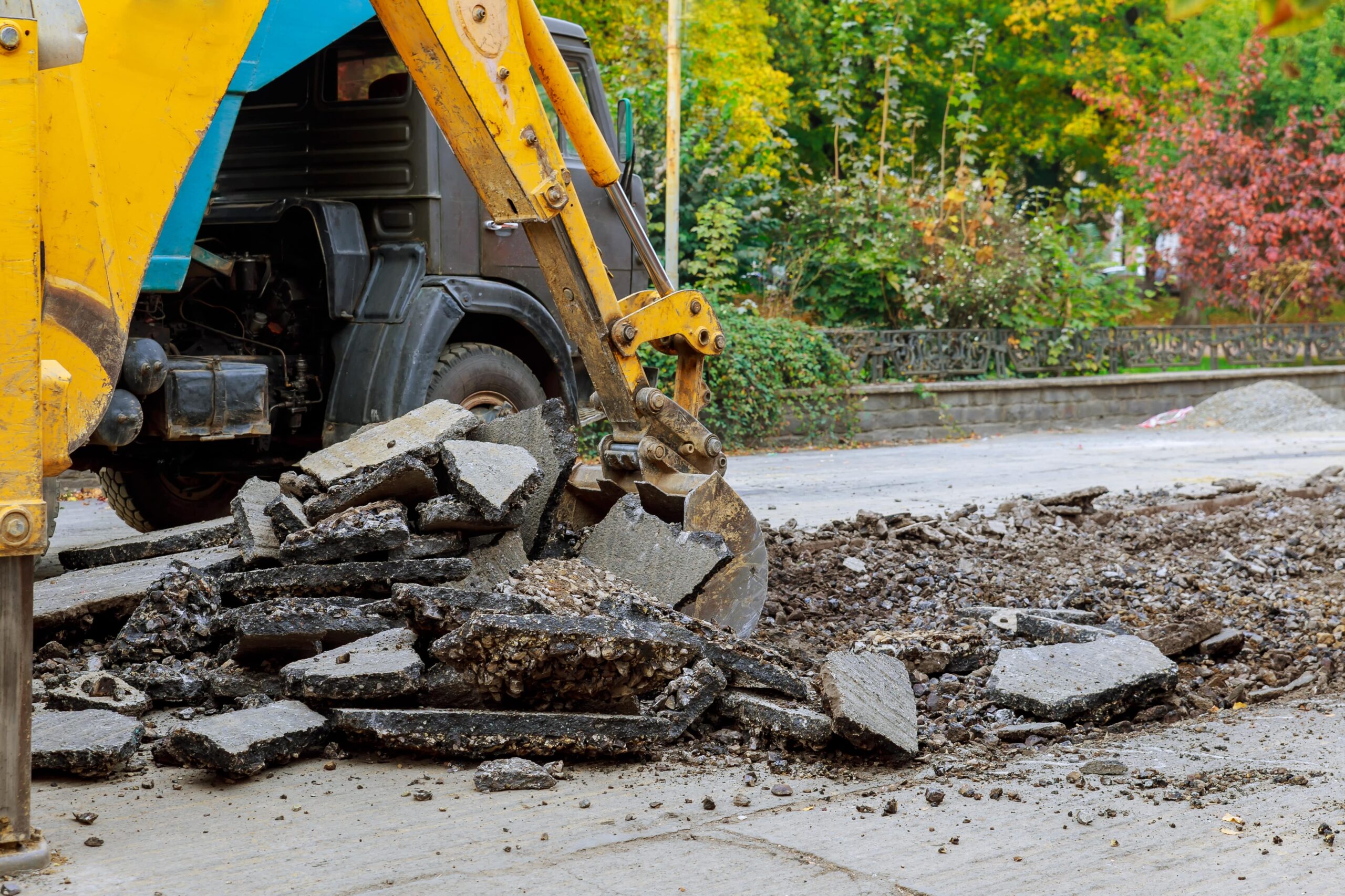 Earthmoving machine breaking up concrete